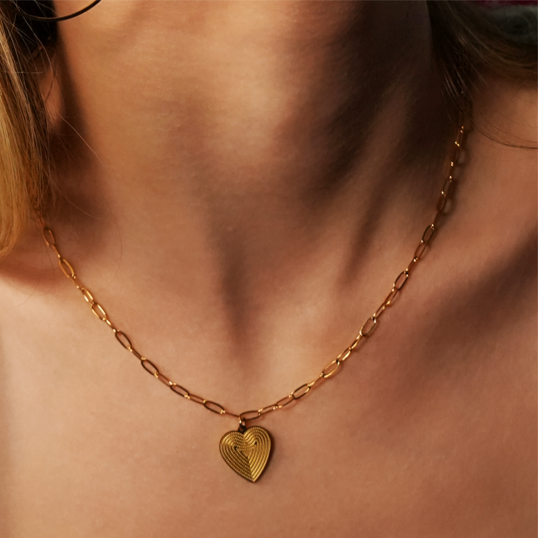 Mini Paper Clip Chain Anchoring a Patterned Heart Charm in Gold