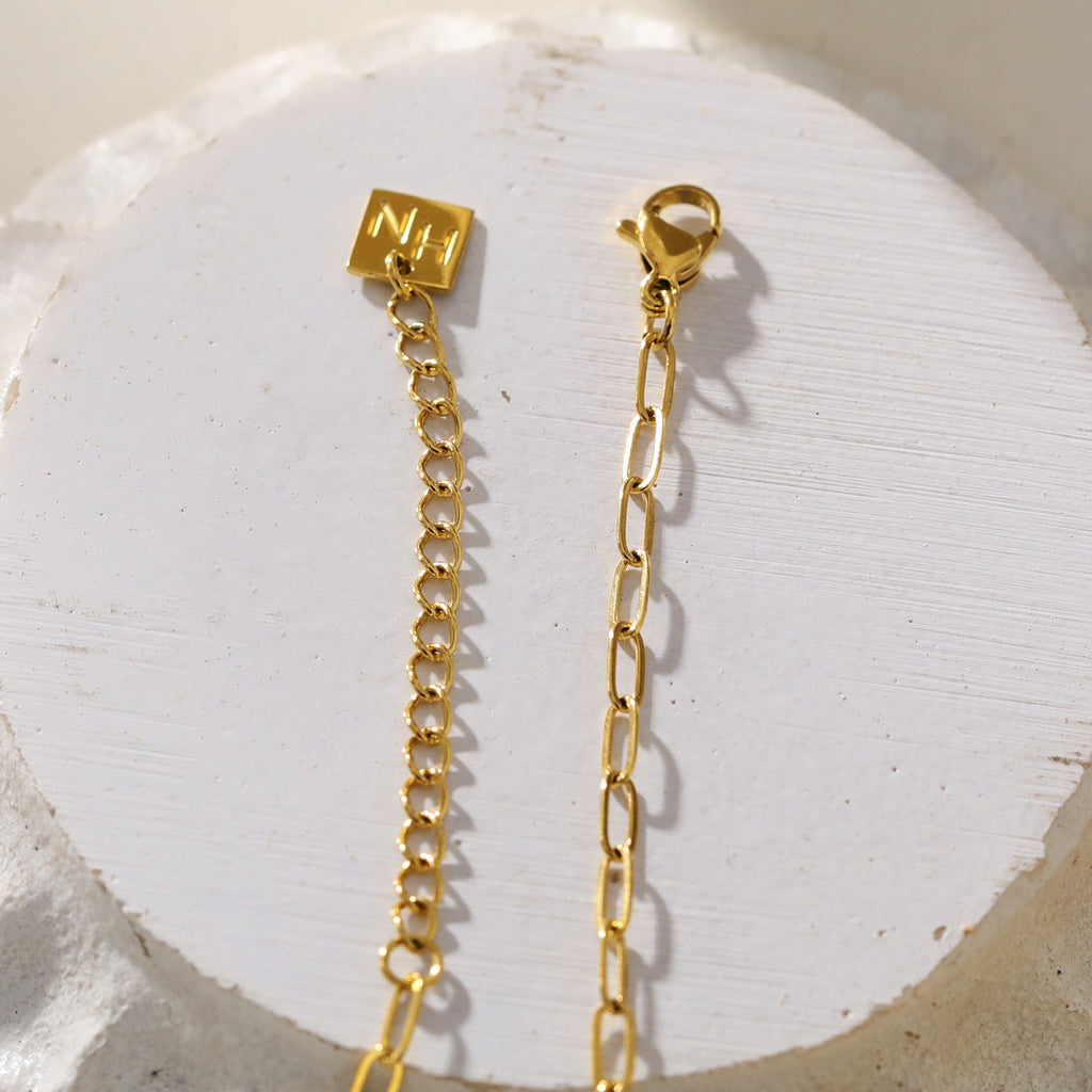 Mini Paper Clip Chain Anchoring a Patterned Heart Charm in Gold