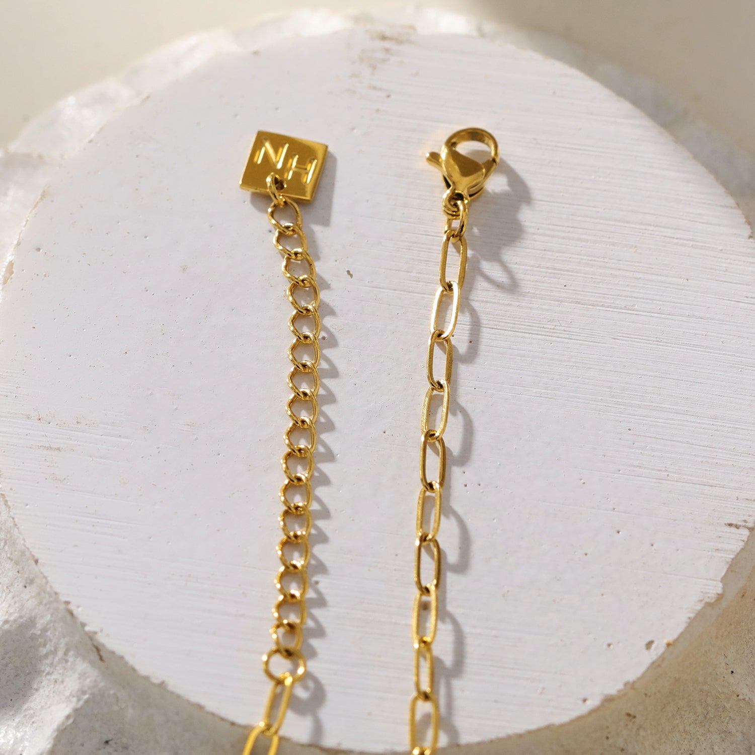 Mini Paper Clip Chain Anchoring a Patterned Heart Charm in Gold
